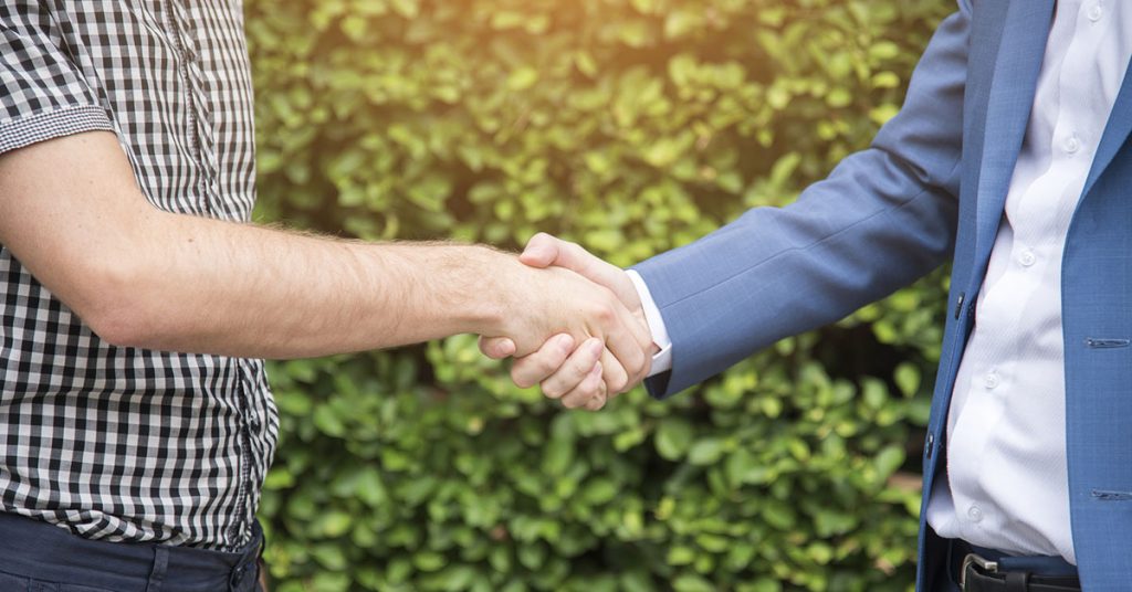 Two people meeting and shaking hands