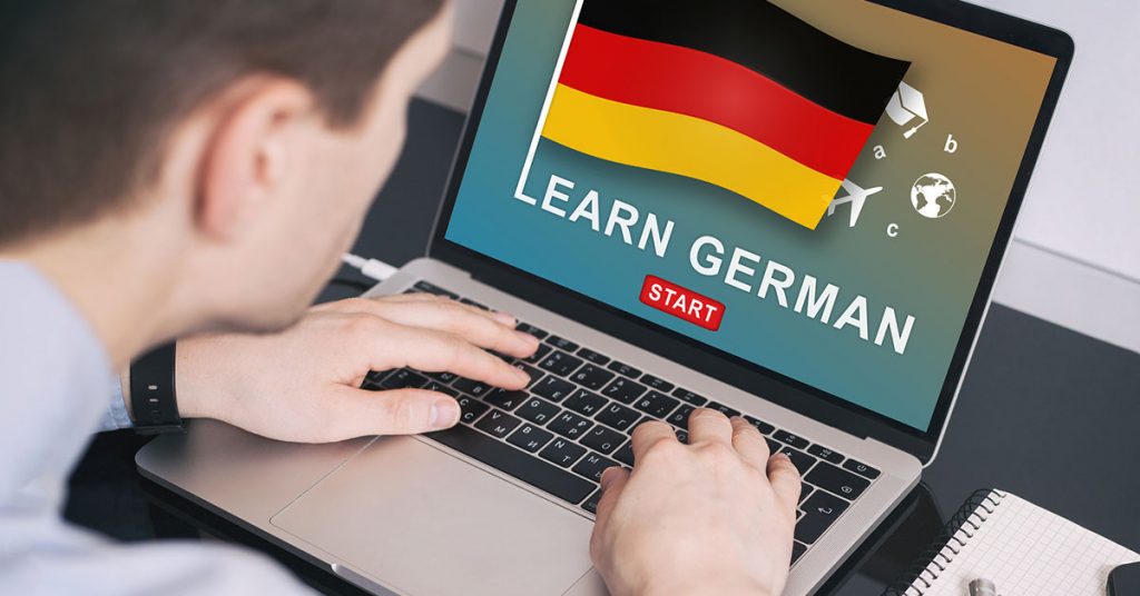 A man learning German on a computer