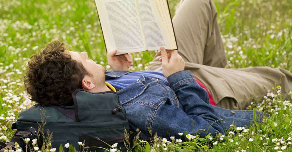 Man reading a book to learn a language